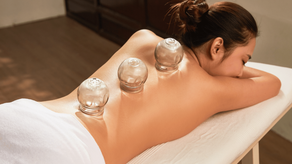 woman on her stomach and cupping on her back