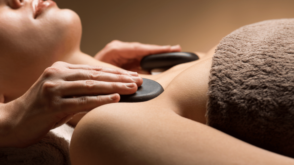 woman receiving hot stone treatment