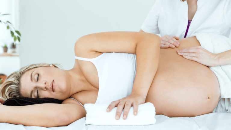 pregnant woman on her side getting a massage